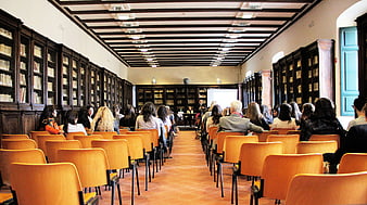 Audience attending a lecture in a historic library hall