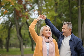 Happy Senior Couple Dancing in Autumn Park