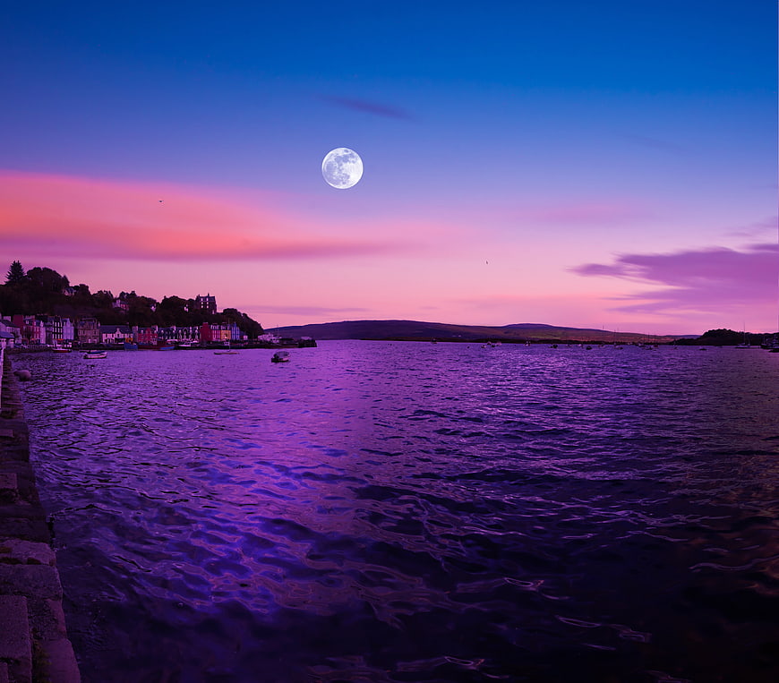 Full Moon Rising Over Tobermory Harbor At Dusk In Scotland