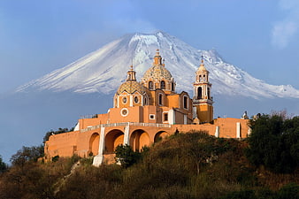 Orange Church with Snow-Capped Volcano Background