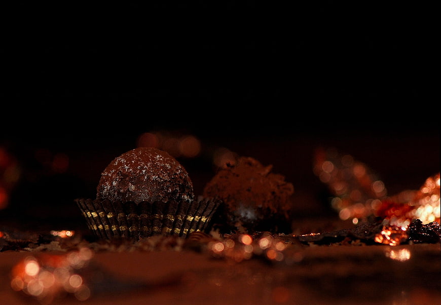 Dark Chocolate Truffles With Cocoa Powder And Gold Foil On Black Background