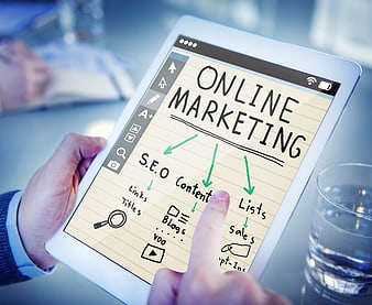 Hand holding tablet with online marketing SEO strategy diagram