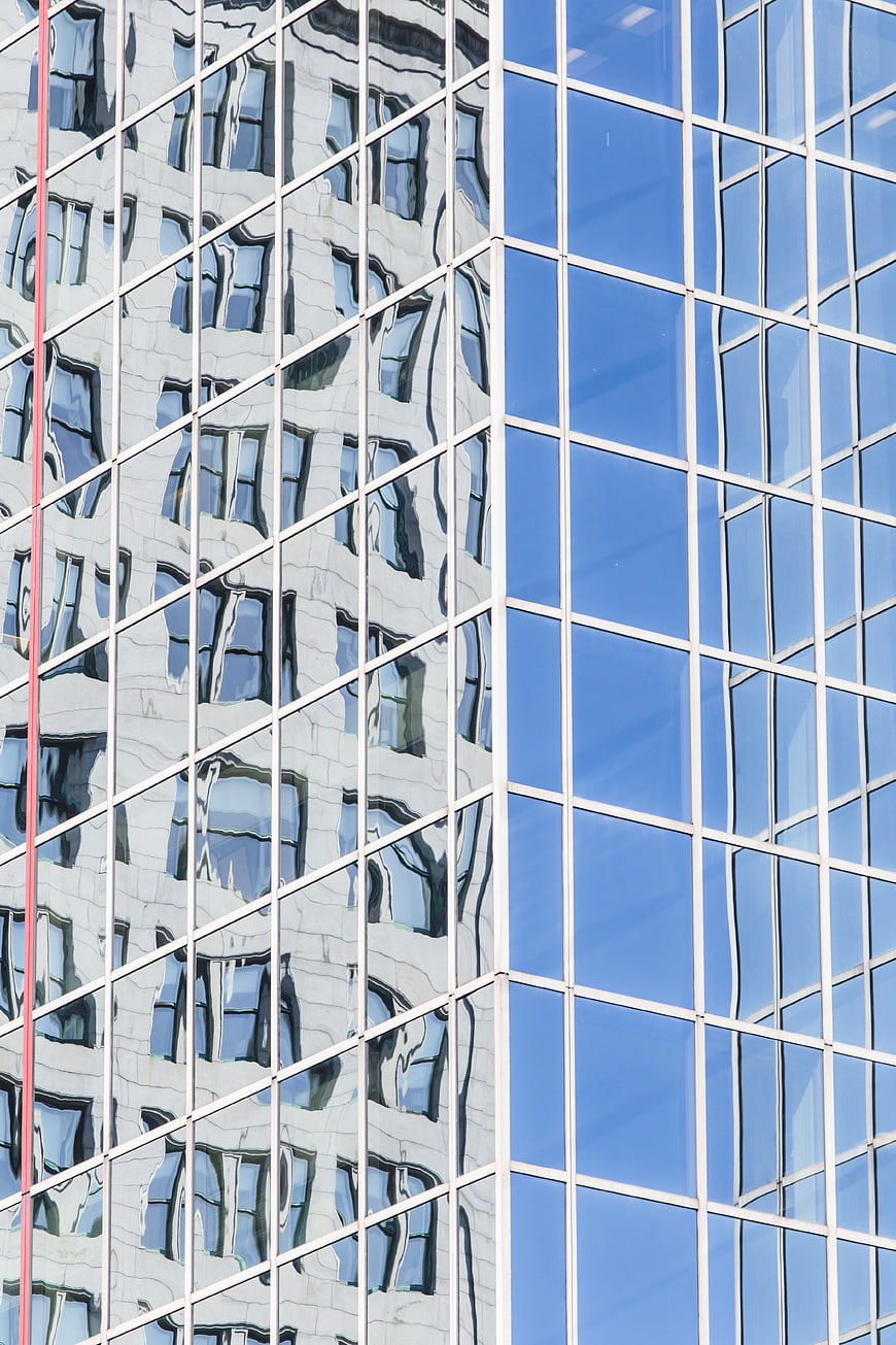 Modern Glass Building Facade with Distorted Reflections