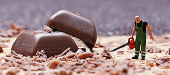 Miniature Worker Cleaning Chocolate Shavings With Leaf Blower