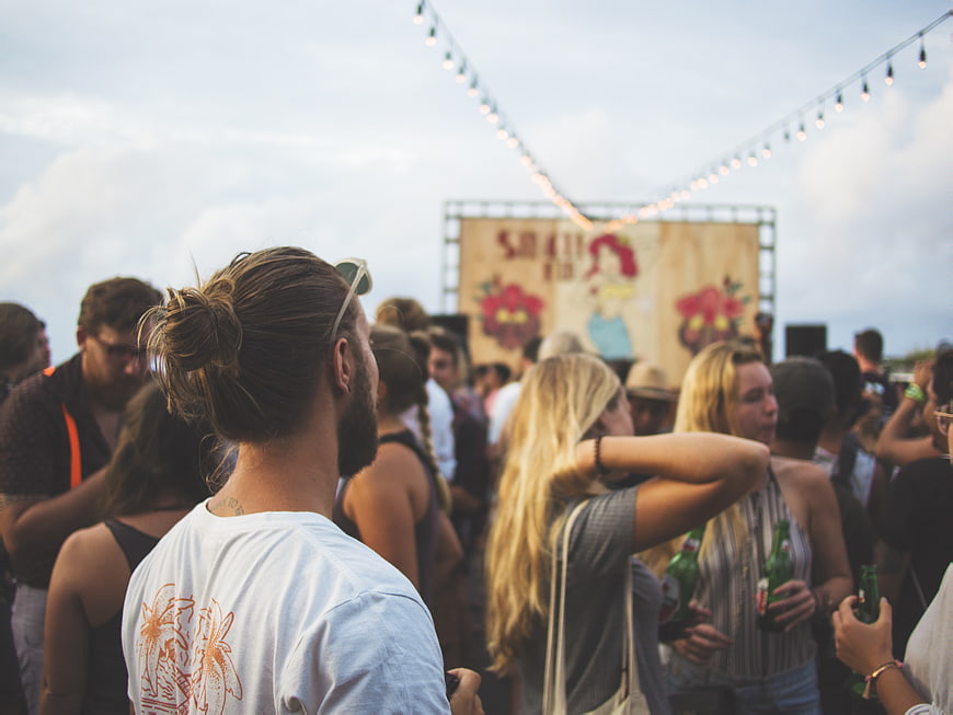 Crowd at Outdoor Music Festival with String Lights