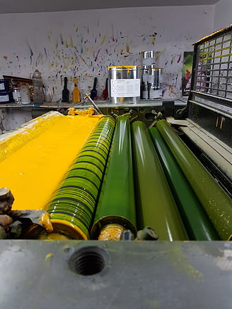 Industrial printing press rollers with yellow ink