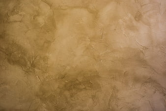 Textured beige wall surface with abstract patterns