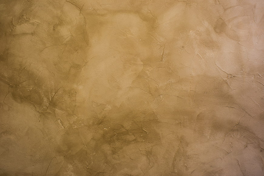 Textured beige wall surface with abstract patterns