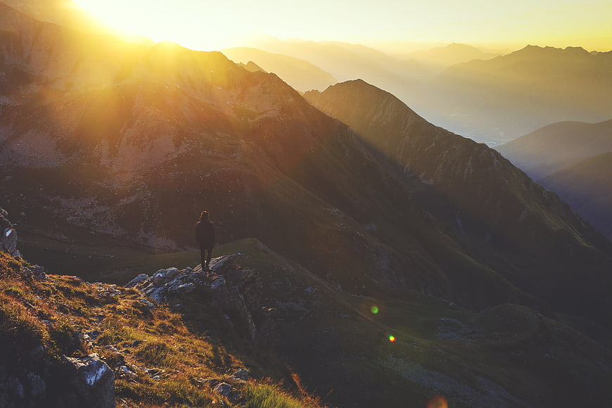 Silhouette of Hiker on Mountain Ridge at Golden Hour