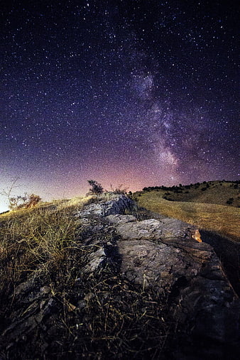 Milky Way Galaxy Over Rocky Hillside at Night