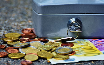 Gray Safe Box with Euro Cash and Key on Gravel