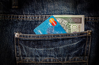 Cash and credit card in blue jeans pocket