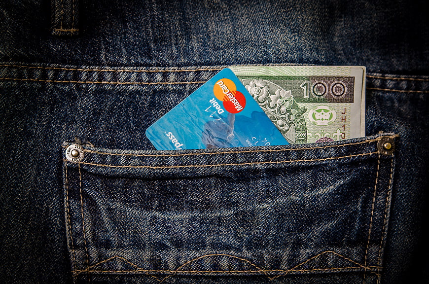 Cash and credit card in blue jeans pocket