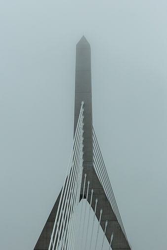 Modern cable-stayed bridge tower in thick fog