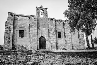 Black and white photo of ancient stone church facade