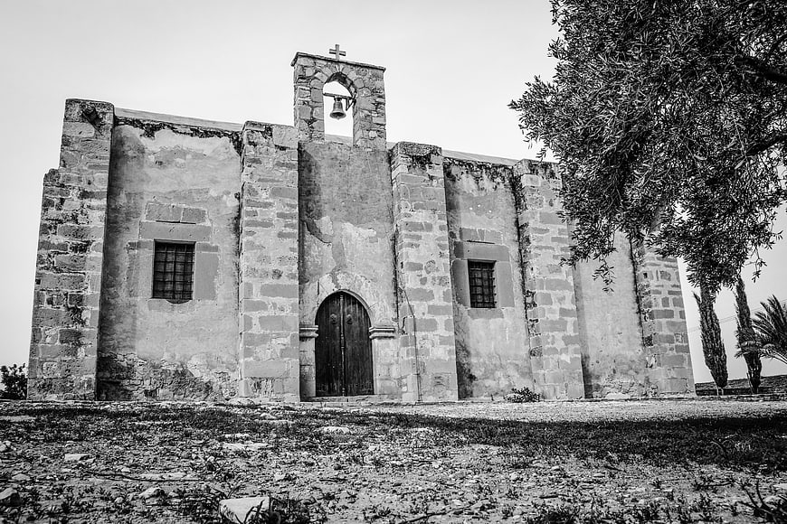 Black and white photo of ancient stone church facade