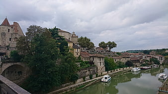 Historic French village on the Baïse river with boats