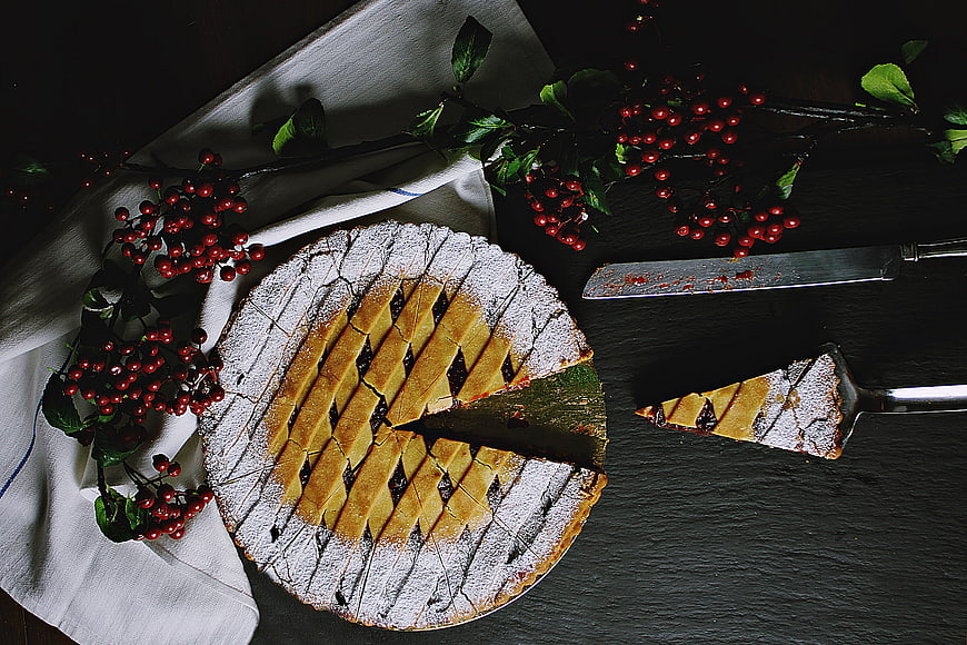 Overhead view of rustic cherry pie with lattice crust and berries