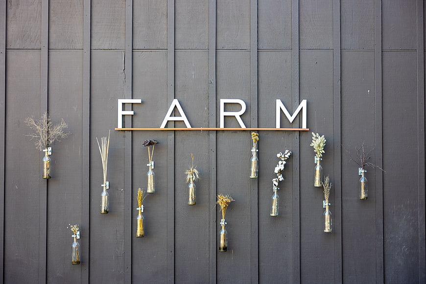 Rustic Farm Sign with Dried Flowers on Barn Wall