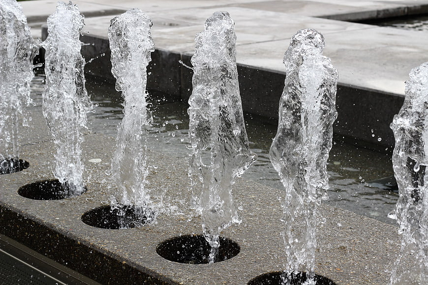 Close-up of water jets spraying from a modern outdoor fountain