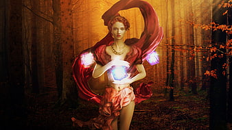 Fantasy woman with glowing magic crystals in autumn forest