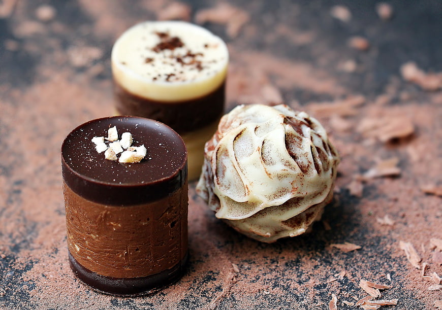 Gourmet chocolate truffles and pralines on rustic background
