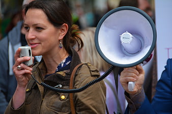 Woman Speaking into Megaphone at Outdoor Event
