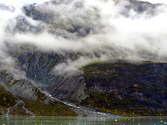 Misty mountain landscape with lake and autumn foliage