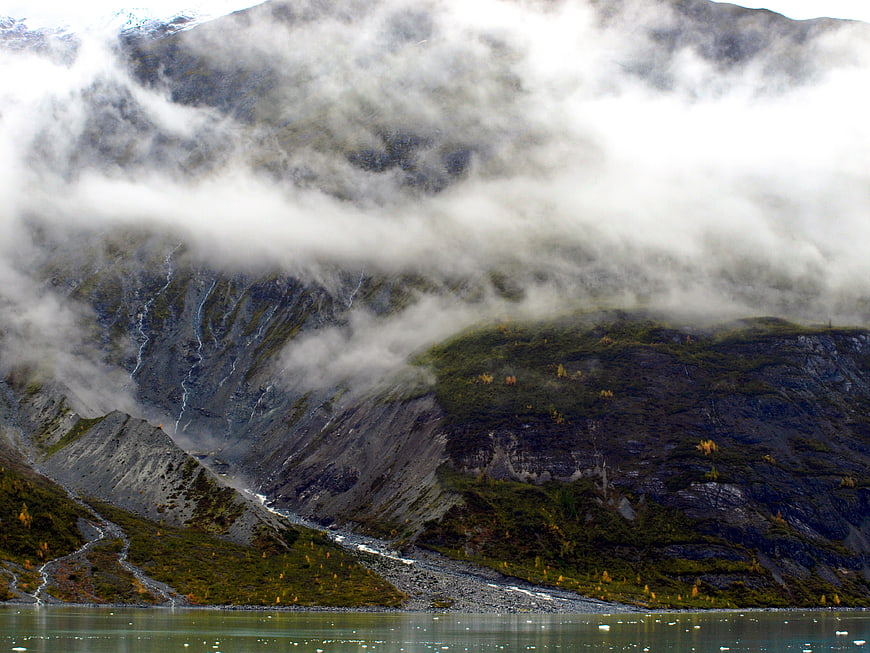 Misty mountain landscape with lake and autumn foliage