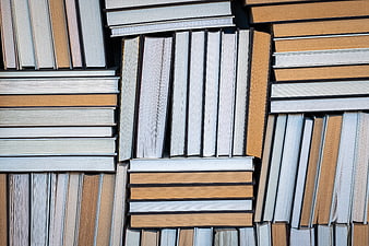 Top View of Stacked Books in Warm Tones