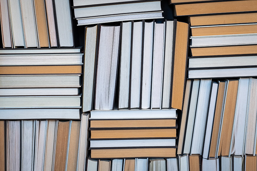 Top View of Stacked Books in Warm Tones