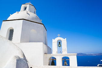 White Greek Orthodox Church with Bells in Santorini