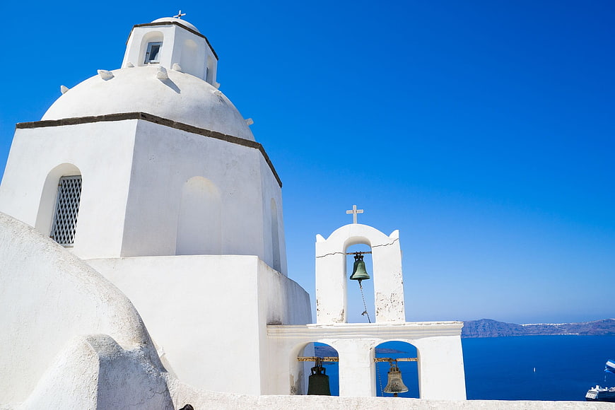 White Greek Orthodox Church with Bells in Santorini