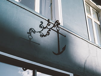 Decorative Iron Anchor Ornament on Blue Building Facade