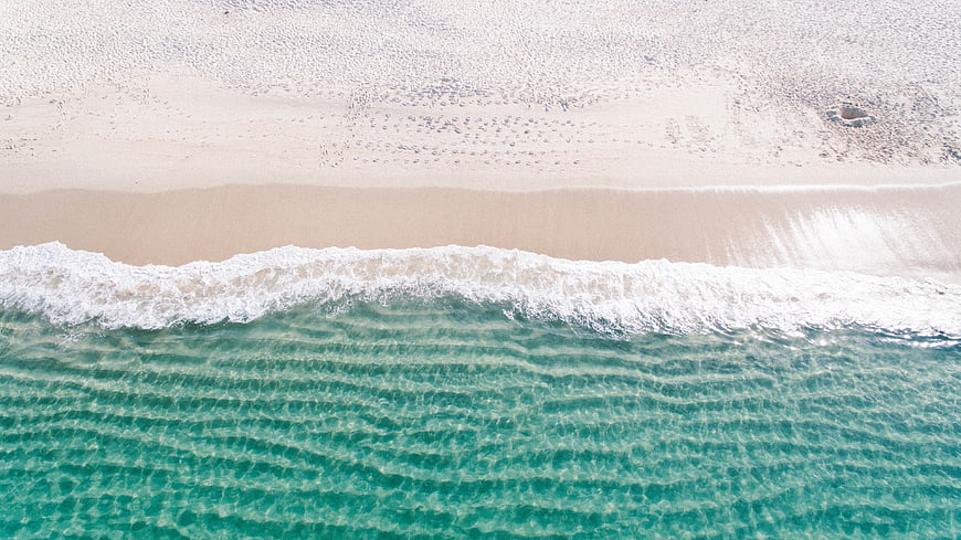 Aerial View of Turquoise Ocean Waves Crashing on Sandy Beach