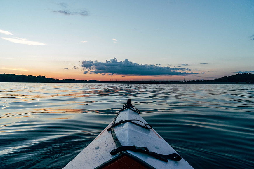 Kayak Bow on Calm Water at Sunset