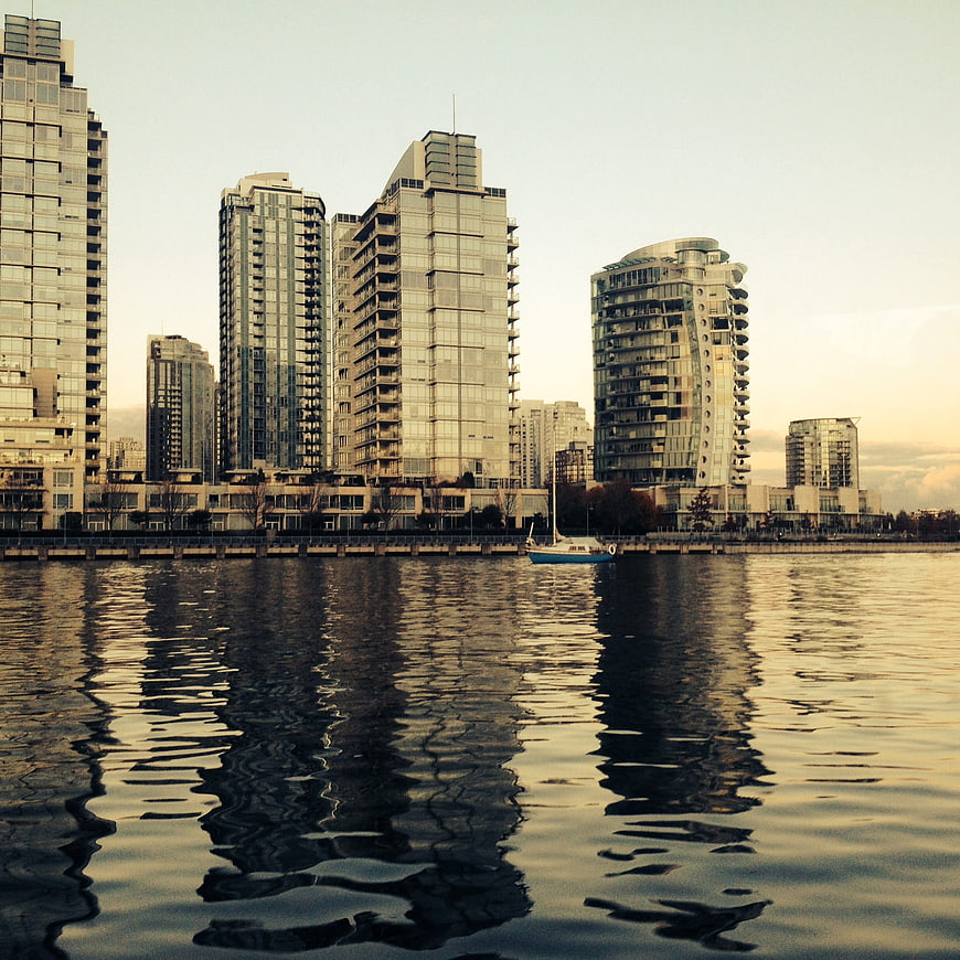 Modern city skyline with skyscrapers reflecting in calm water
