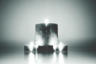 Black and white candles with dramatic lighting and reflections