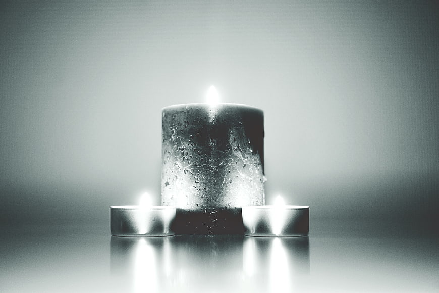 Black and white candles with dramatic lighting and reflections