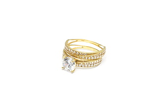 Gold diamond ring set on white background