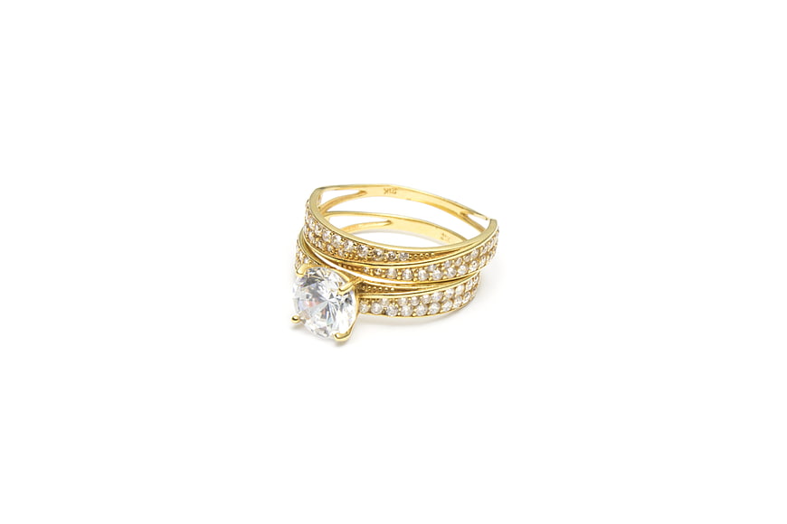 Gold diamond ring set on white background