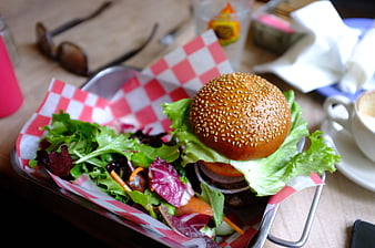 Delicious burger and salad meal in a metal basket