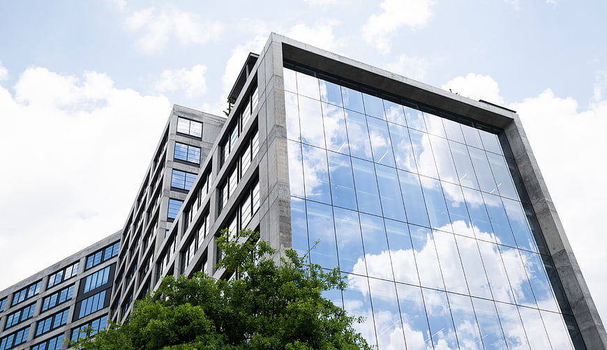 Modern Glass Office Building with Sky Reflection