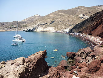 Red Beach Santorini Greece with Boats and Swimmers
