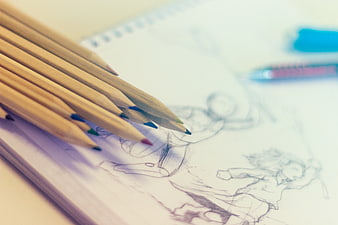 Colored Pencils on Sketchbook with Anime Character Drawing
