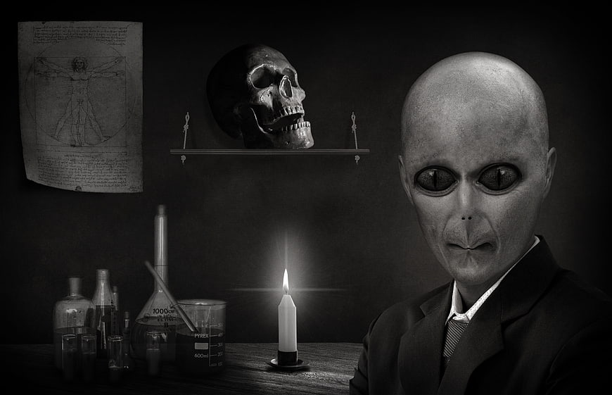Black and white portrait of alien in suit with skull and lab equipment