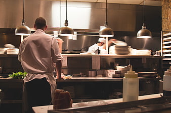Chefs working in a busy professional restaurant kitchen