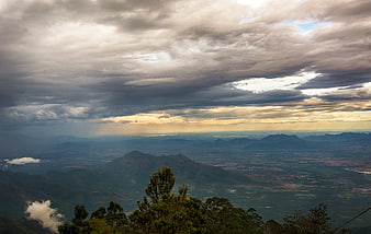 Dramatic mountain landscape with clouds and sun rays