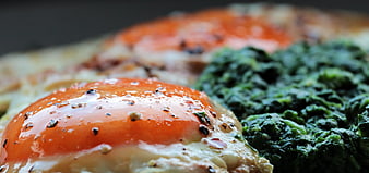 Close-up of fried egg with spinach and pepper
