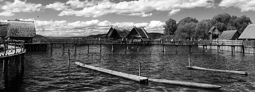 Black and white panoramic view of pile dwellings on Lake Constance